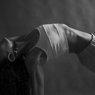 Silhouette of a person in a balancing yoga pose.